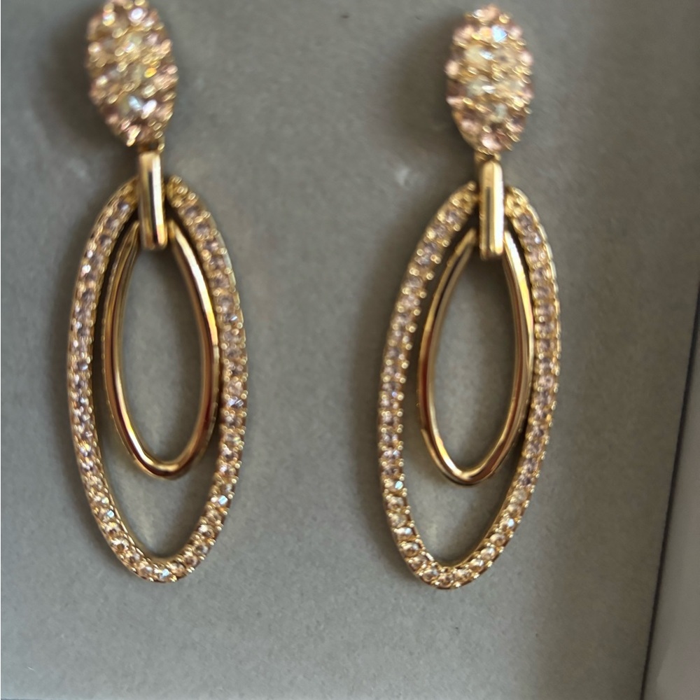 Judith Leiber gold colored earrings with sparkles